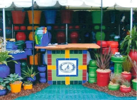 Kieran&rsquo;s Bar, a mosaic counter with the Morris & James plaque, on a display stand among glazed pots
