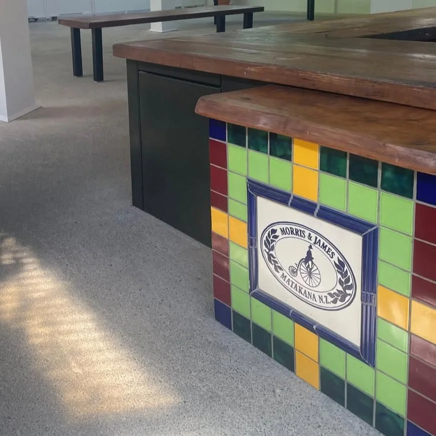 The tiled end of Kieran&rsquo;s Bar in the showroom, with the Morris & James plaque framed in cobalt