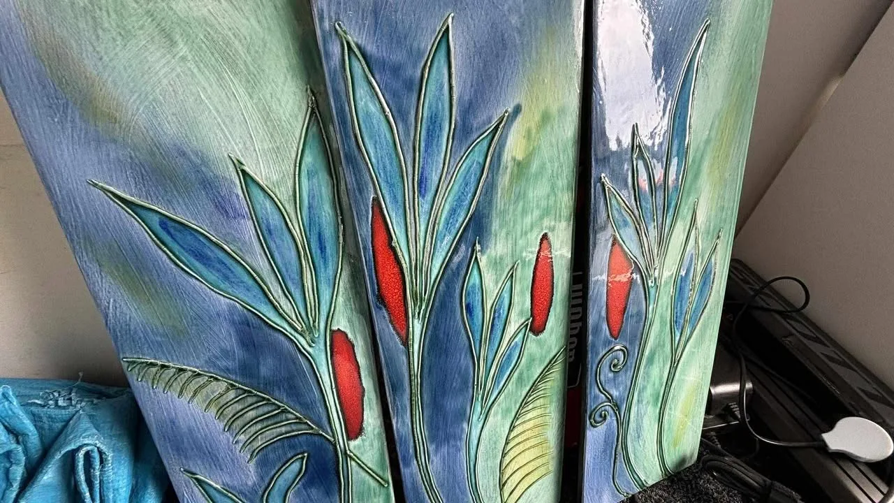 Three blue-green wall panels with sections of lifted, cracked glaze