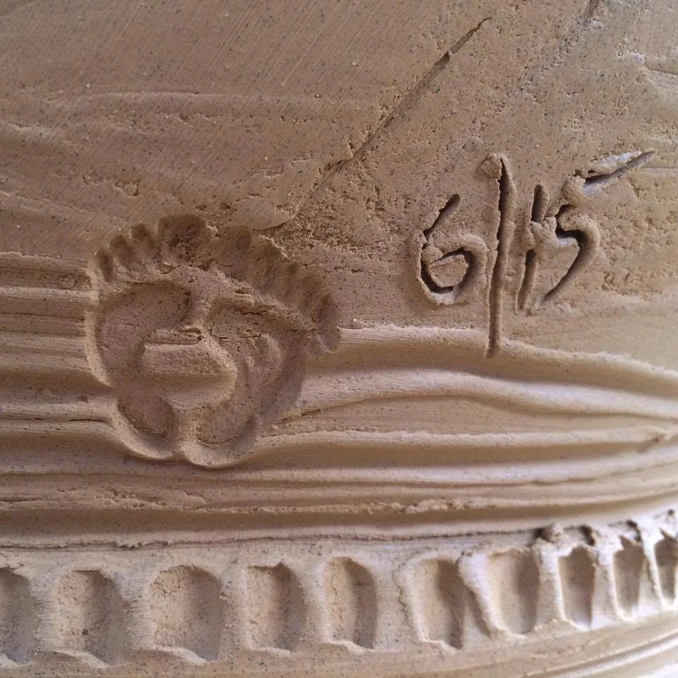 The impressed foot mark of Ian Foote beside a hand-written 6/15 date on a terracotta pot