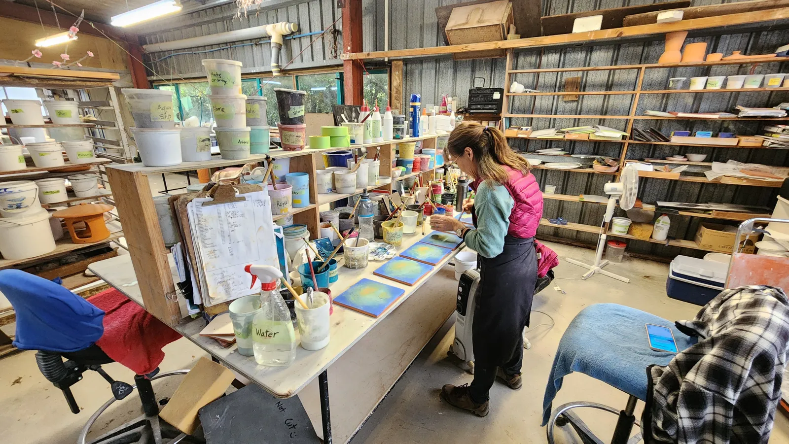 Hand-decorating tiles in the decorating room