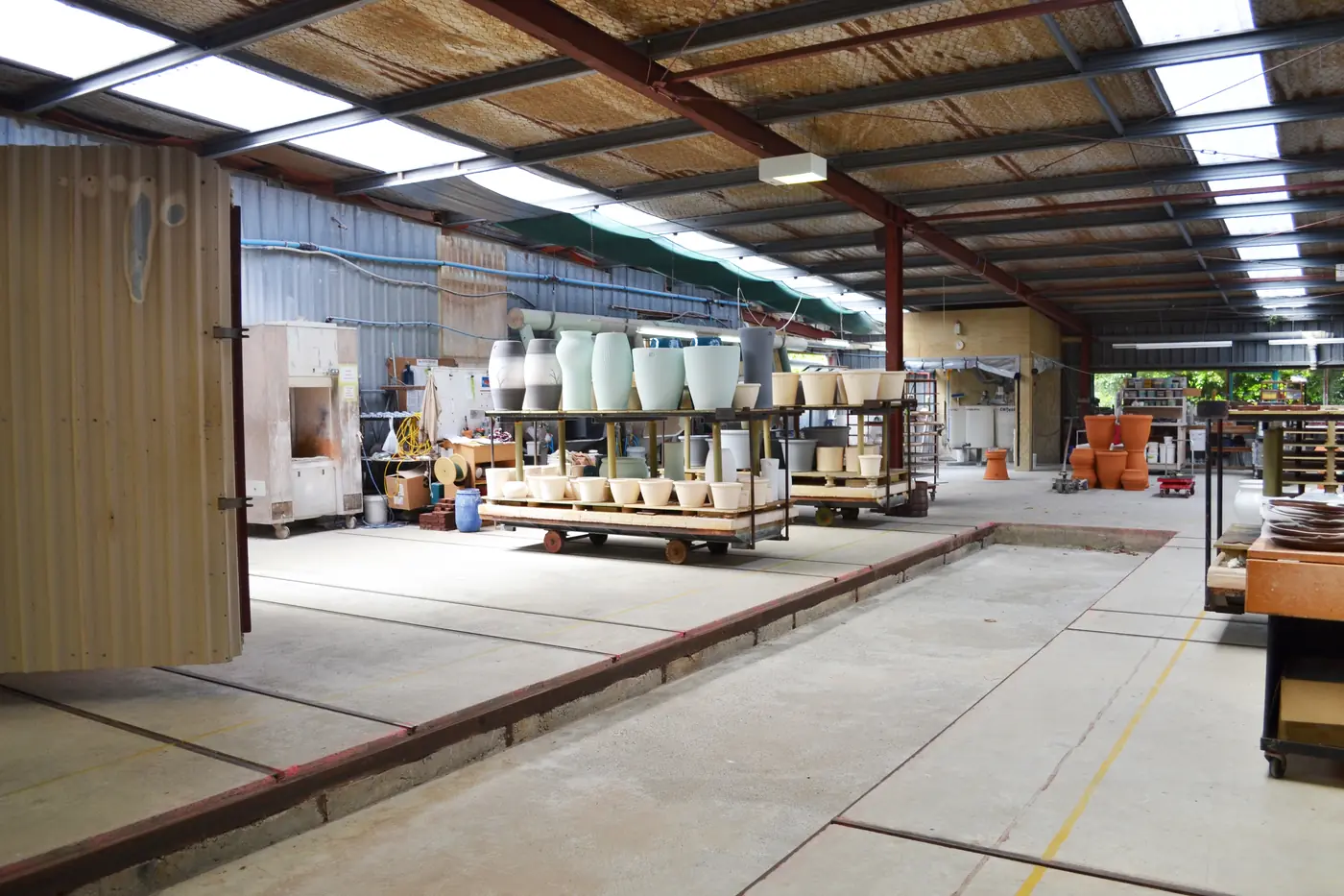 Spray-glazed pots on the kiln car