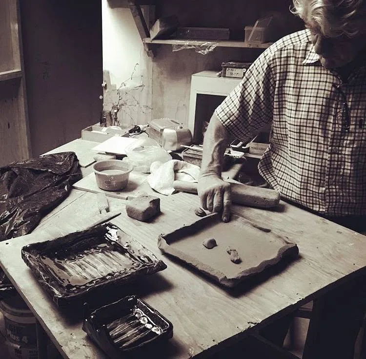 Anthony shaping a clay dish