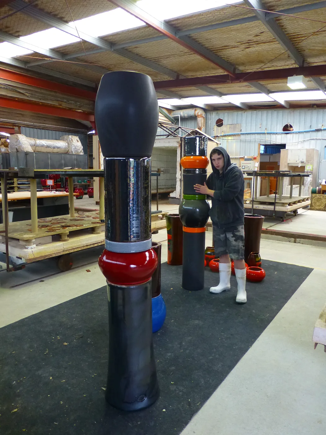 Dark columns with orange, red and green bands in the factory