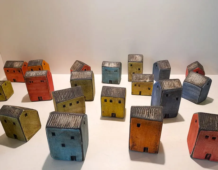Small ceramic houses in orange, red, yellow, blue and green