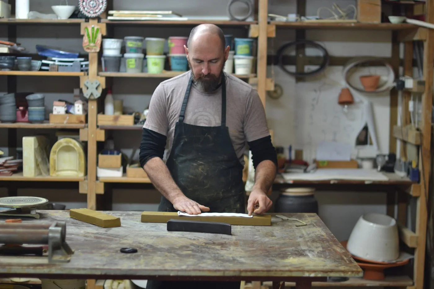 Laying the paper template on a block of clay