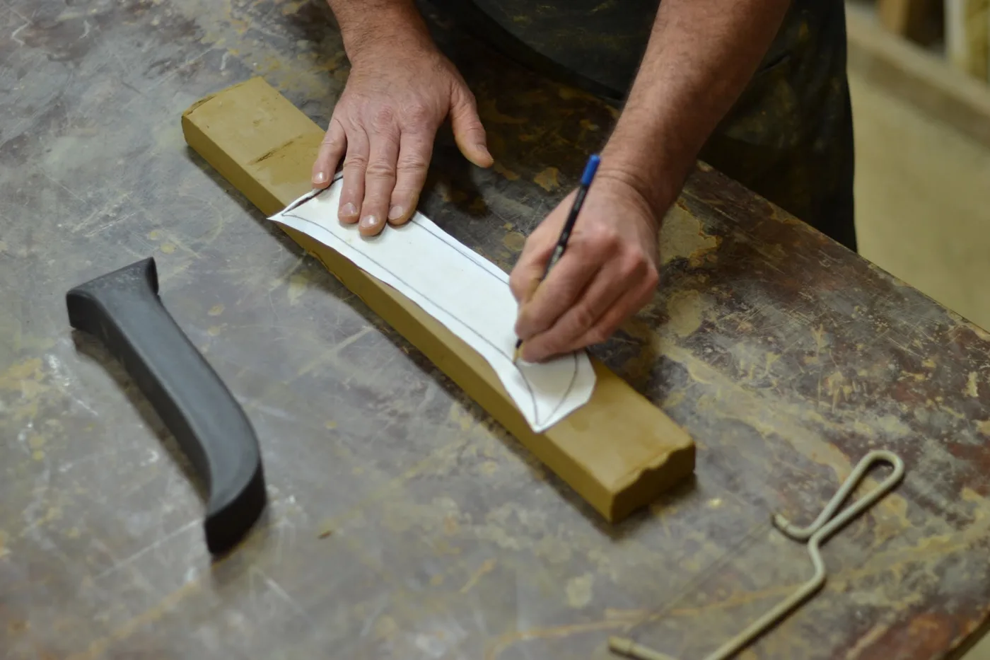 Tracing the J shape onto the clay